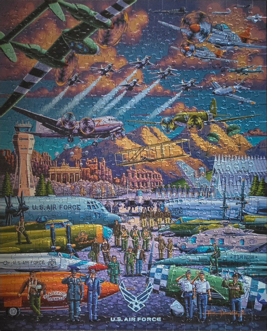 A dynamic collage painting of various U.S. Air Force aircraft from different historical eras and ground personnel.