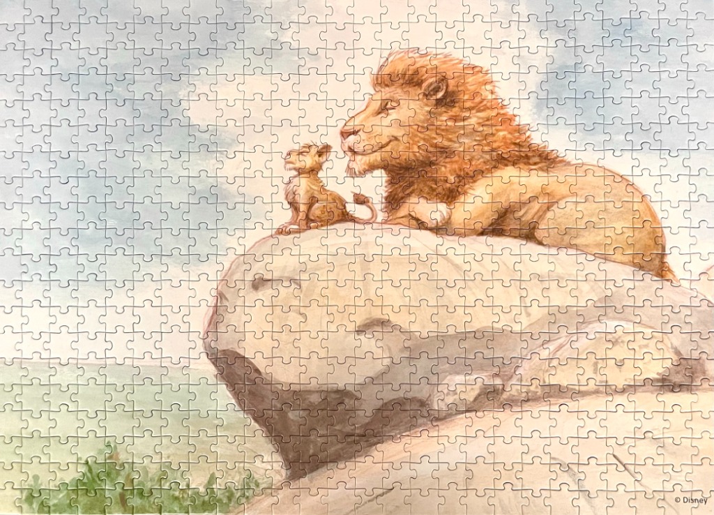 A watercolor painting of a male lion and a small lion cub sitting together on a rocky cliff side.