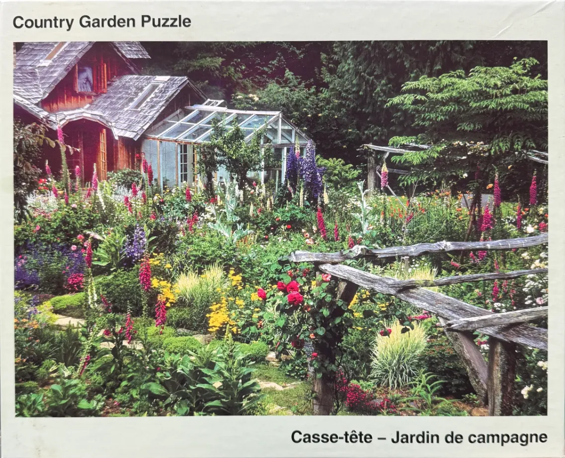 A lush country garden with a rustic red cabin and greenhouse surrounded by vibrant flowers and a weathered wooden fence.