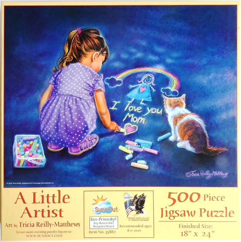 A young girl in a purple dress draws on dark pavement with chalk, accompanied by a small kitten.