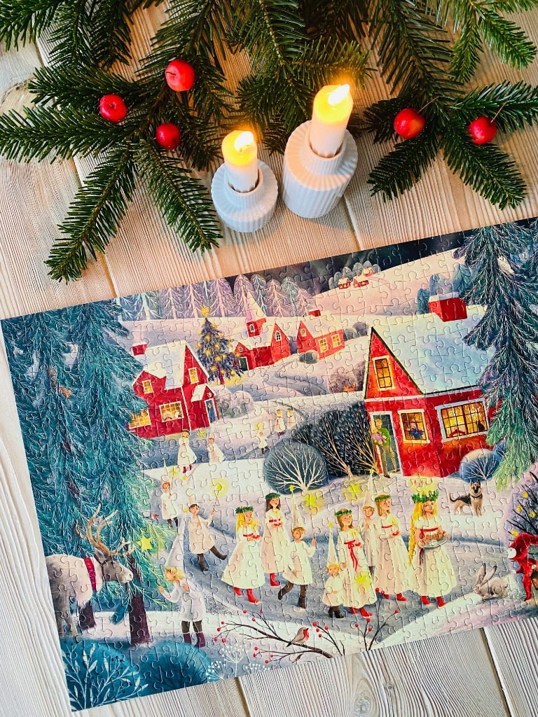 An illustration of a snowy St. Lucia procession in a Scandinavian village at twilight.