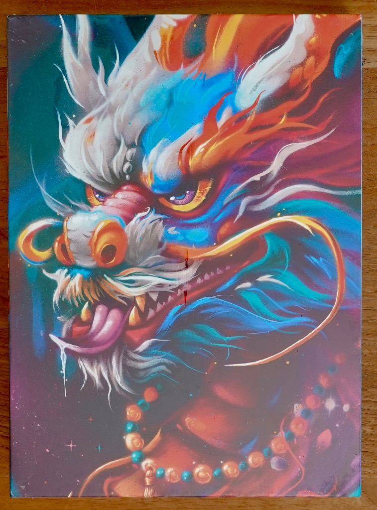 An intense, vibrant illustration of a dragon head facing left against a cosmic, multi-colored background.