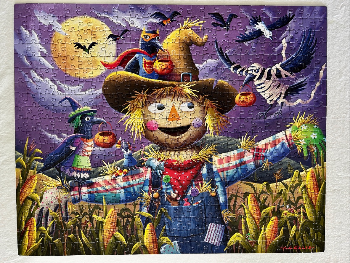 A whimsical illustration of a smiling scarecrow surrounded by crows in costume in a moonlit cornfield at Halloween.