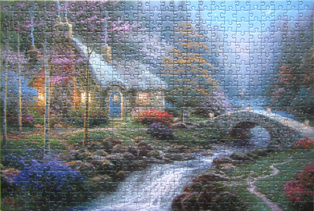 A cozy stone cottage in a lush, moonlit garden with a flowing stream and stone bridge at night.
