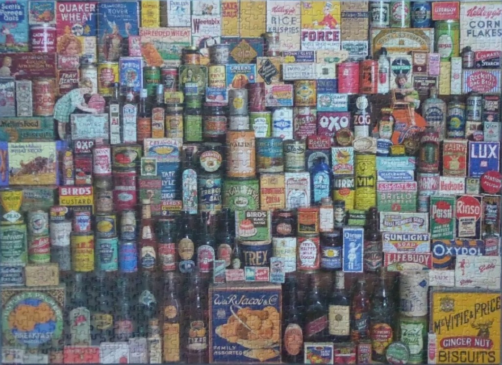 A collage of vintage product packaging, tins, and bottles in a dense, stacked arrangement.