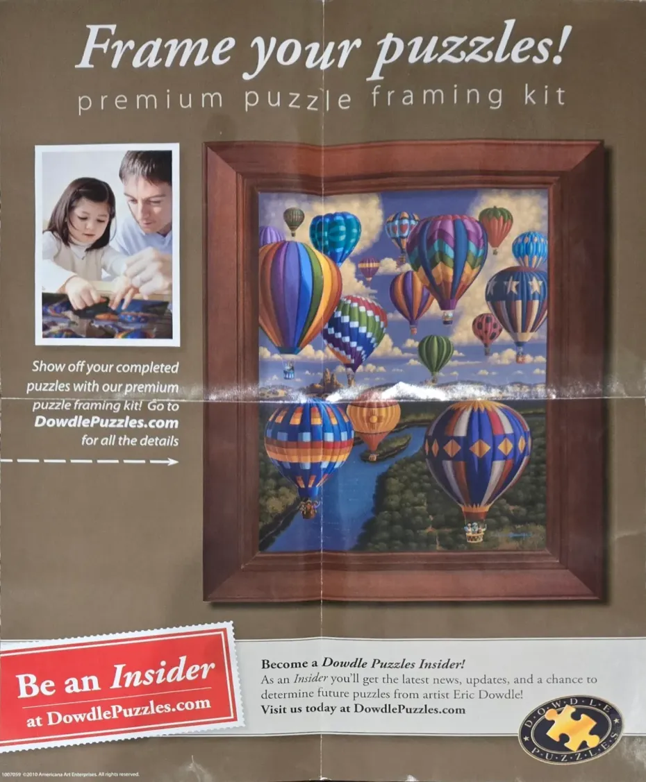 A painting of colorful hot air balloons floating over a river, framed in wood, with inset photos of people.