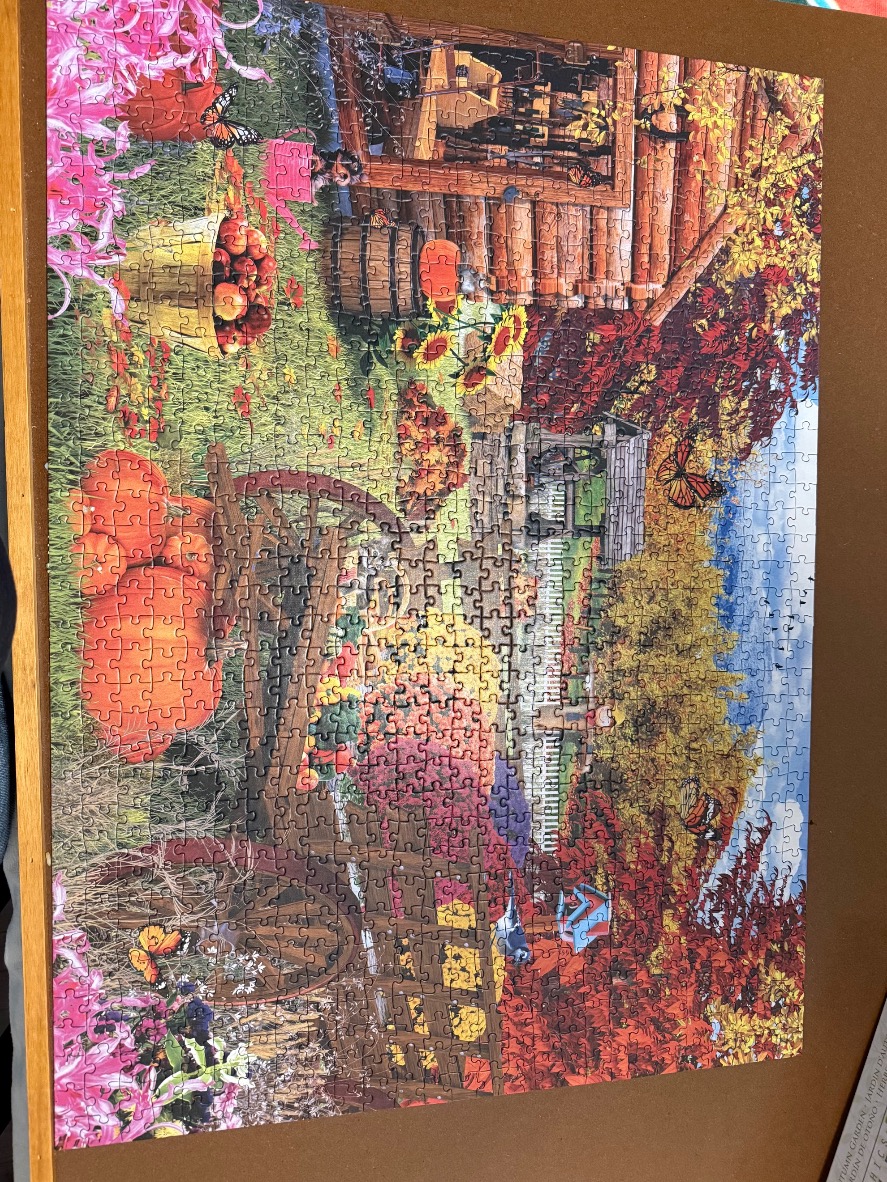 A cozy autumn garden scene with a wooden cart, pumpkins, and monarchs butterflies.