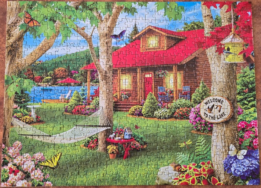 A cozy log cabin lakeside retreat with a red roof, lush garden, and butterflies.