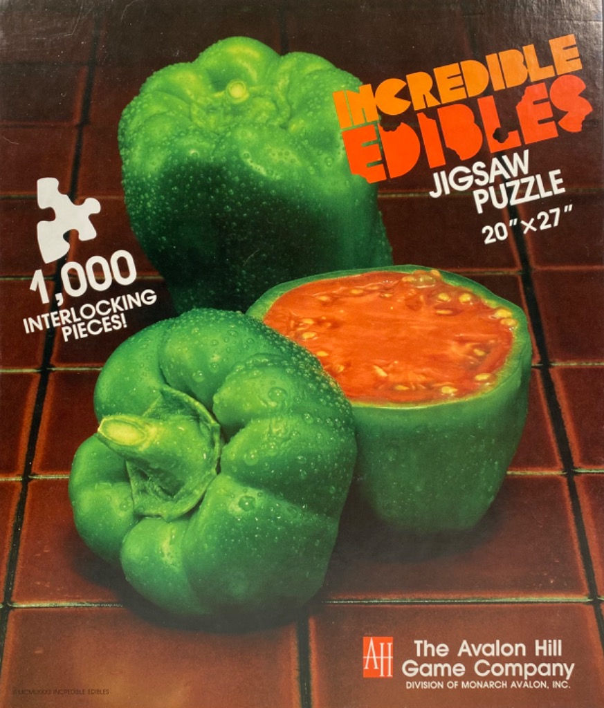 Two vibrant green bell peppers resting on a brown tiled surface, one whole and one sliced open to reveal a tomato interior.