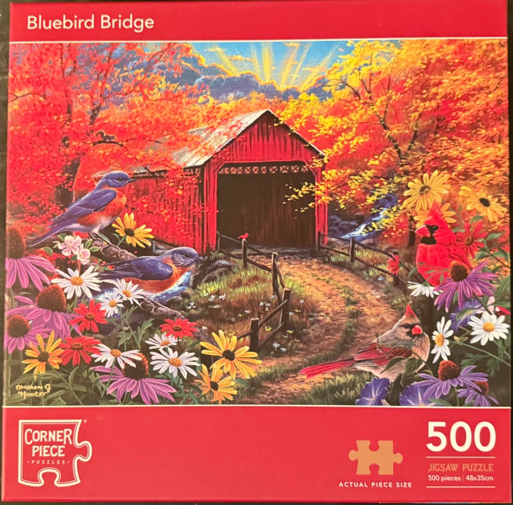 A vivid autumn scene featuring a red covered bridge, bluebirds, and cardinals surrounded by colorful wildflowers.
