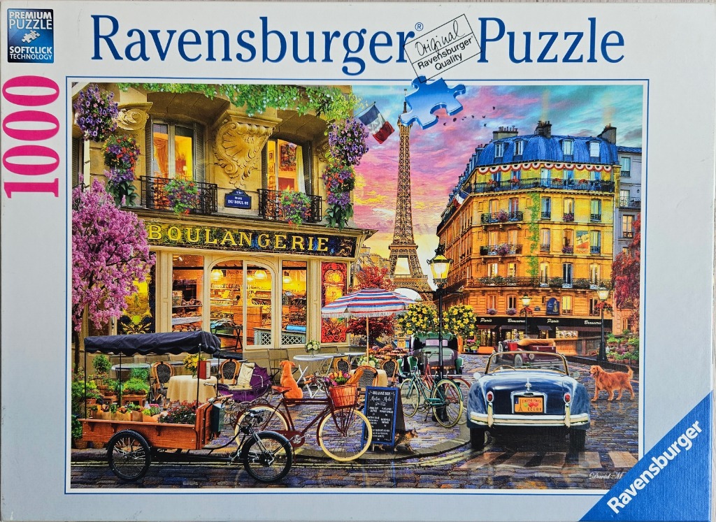 A Parisian street scene with a boulangerie, the Eiffel Tower in the distance, and vintage cars at sunset.