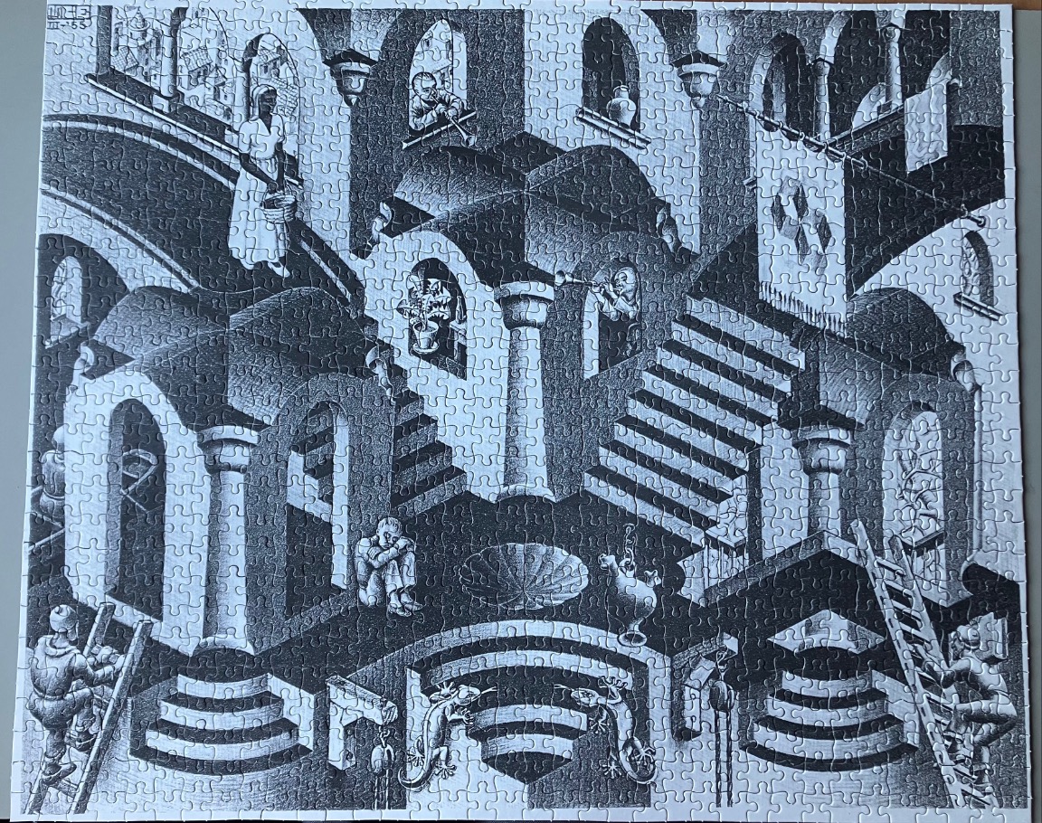 A black and white lithograph featuring an impossible architectural structure with staircases and figures.