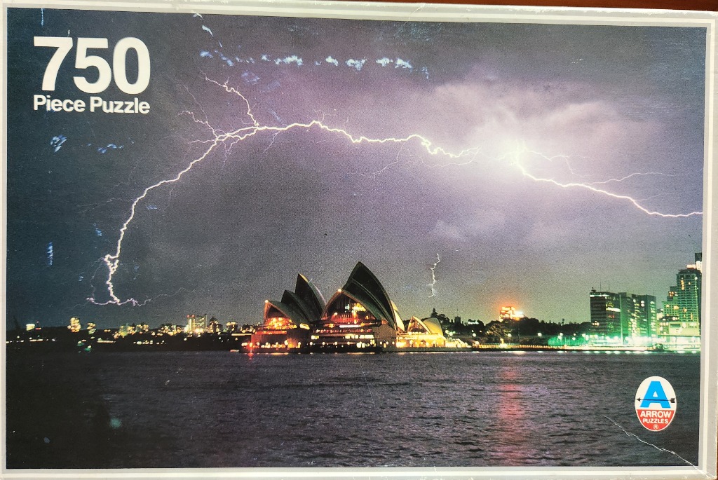 A night photograph of the Sydney Opera House illuminated under a dramatic lightning storm over the harbor.