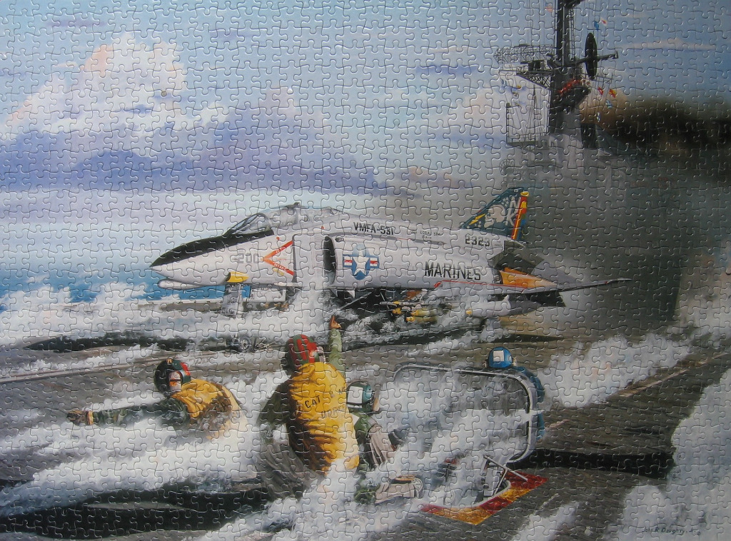 An illustration of a US Marine jet launching from an aircraft carrier deck surrounded by steam and crew members.