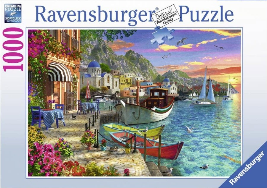 A Mediterranean waterfront scene with a cafe terrace, sailboats, and a village at sunset.
