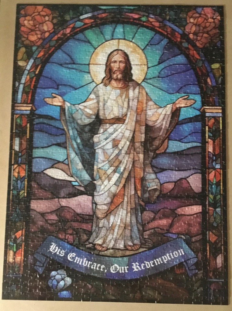 Stained glass style image of Jesus Christ with arms outstretched and the text 