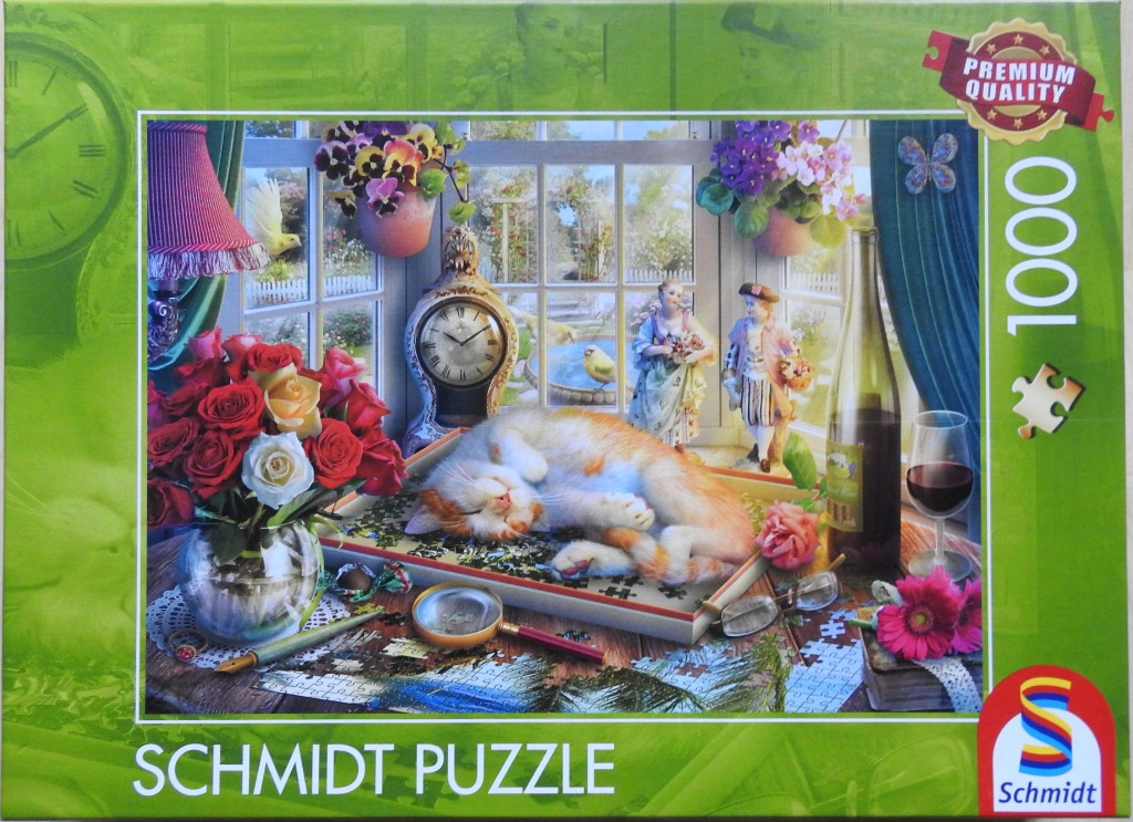An orange and white cat sleeping on a jigsaw puzzle on a wooden table, surrounded by flowers and a garden view.