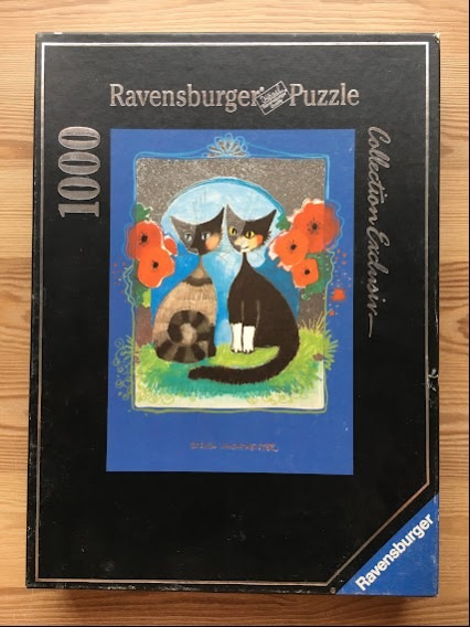 Illustration of two stylized cats sitting side-by-side in a garden setting surrounded by bright red poppies.