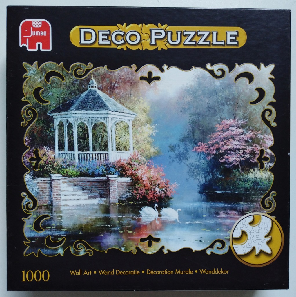 An impressionistic painting of a white gazebo and two swans on a pond, framed by an ornate decorative border.