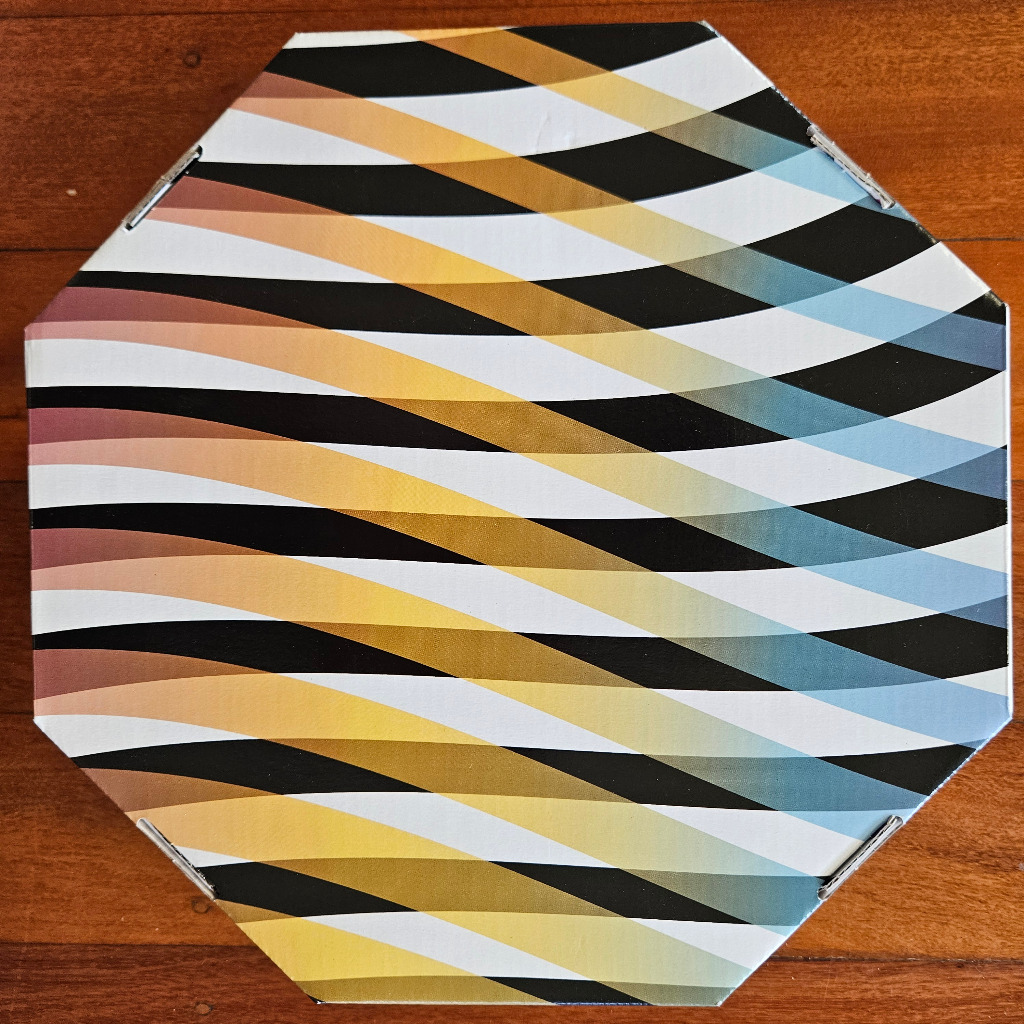 Abstract geometric design of overlapping, wavy black, white, and colour-gradient stripes forming a repeating pattern.