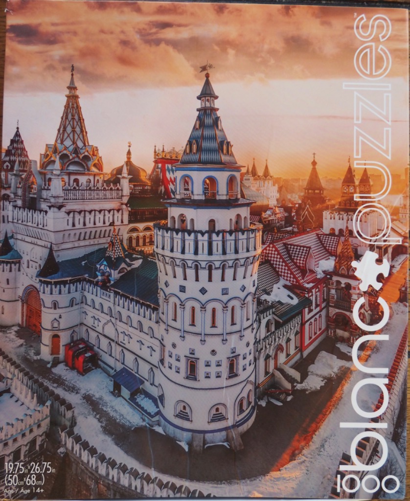 The Izmailovo Kremlin in Moscow under a golden sunset sky with snow on the ground.