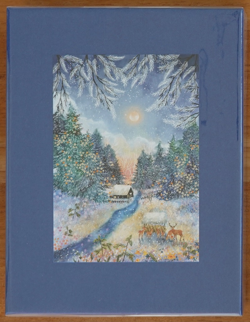 A peaceful snowy winter scene featuring a small cabin, a winding path, and a group of deer by a feeder under a full moon.