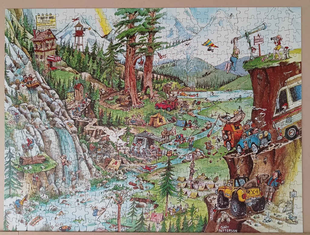 A humorous, busy cartoon scene of a chaotic mountain campground with campers, vehicles, and a waterfall.