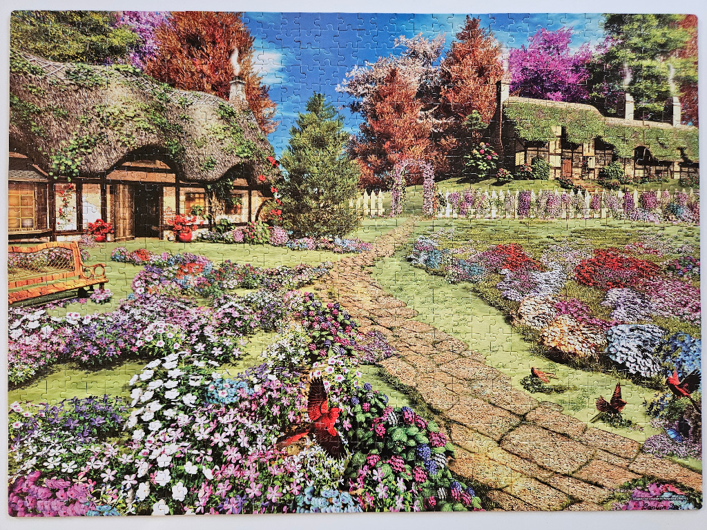 A peaceful English cottage garden in autumn with a stone path, colourful flowers, and red birds.