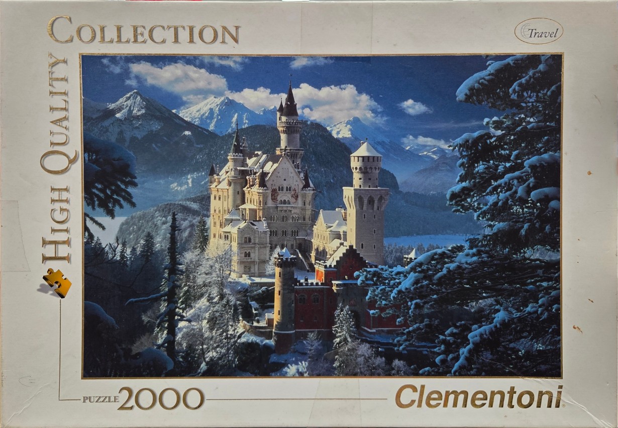 Neuschwanstein Castle nestled in snowy mountains during winter