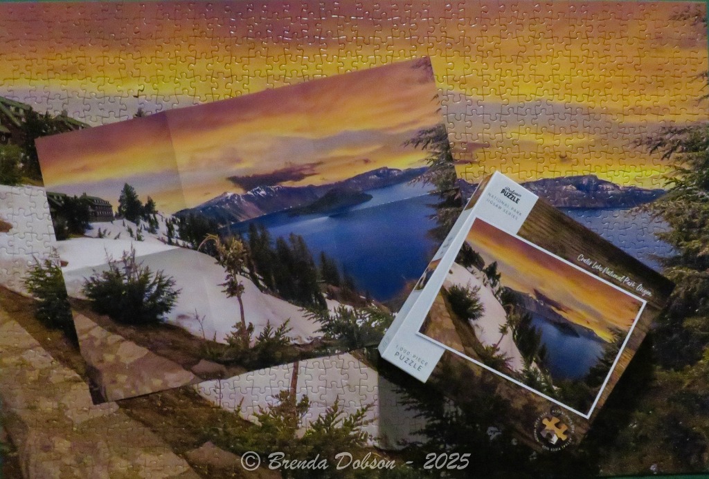 Crater Lake National Park at sunset with snow-covered banks and a scenic lodge.