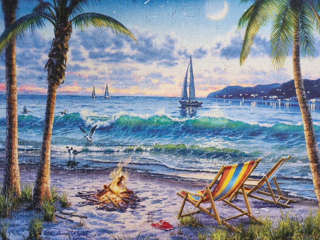 A moonlit tropical beach scene with a bonfire and two beach chairs by the ocean under a starry sky.