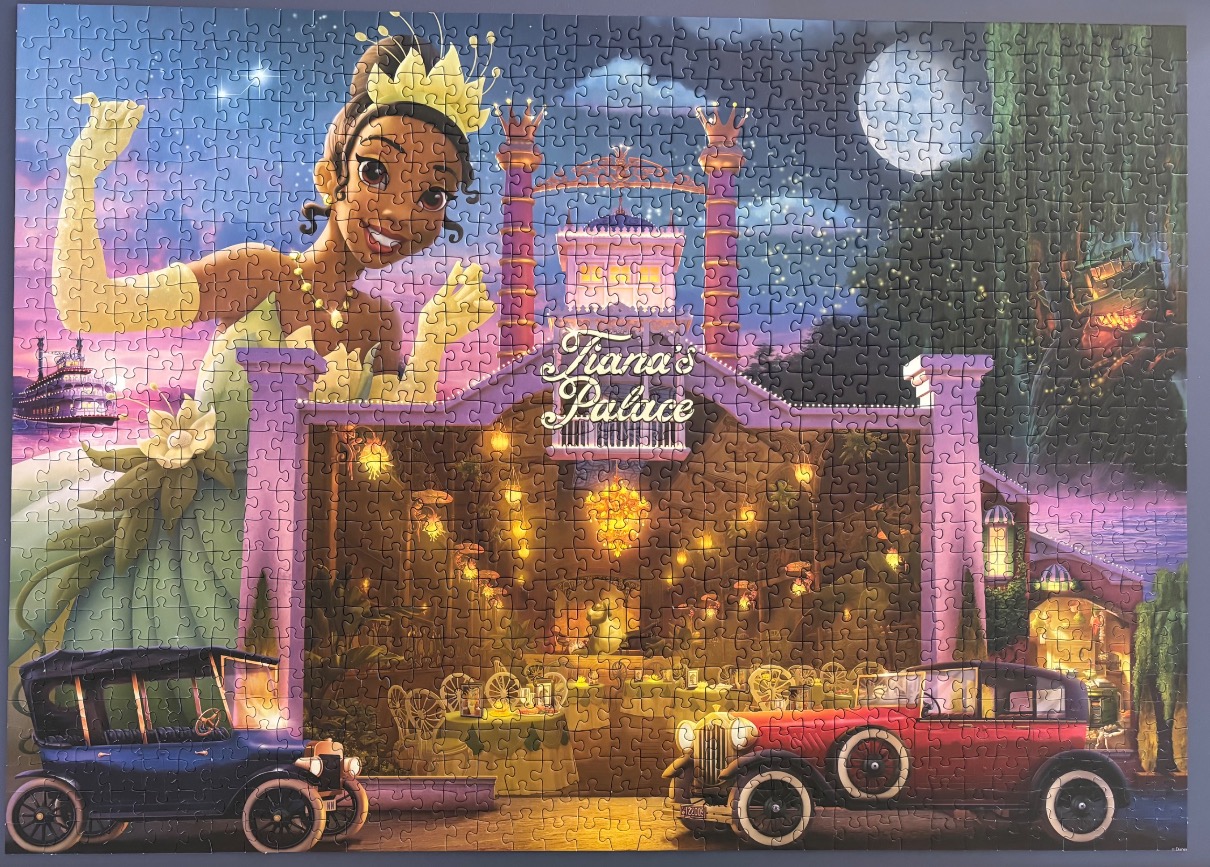 Tiana from The Princess and the Frog standing behind her restaurant, Tiana's Palace, at night.