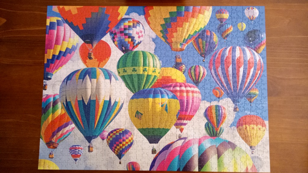 A collection of colorful hot air balloons floating in a bright blue sky.