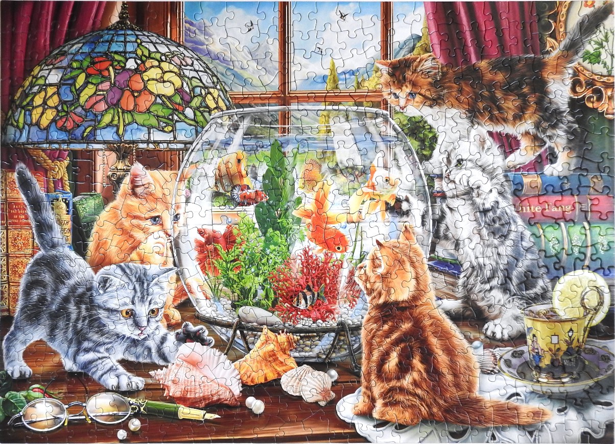 Four kittens observe a fishbowl in a cozy, cluttered room.