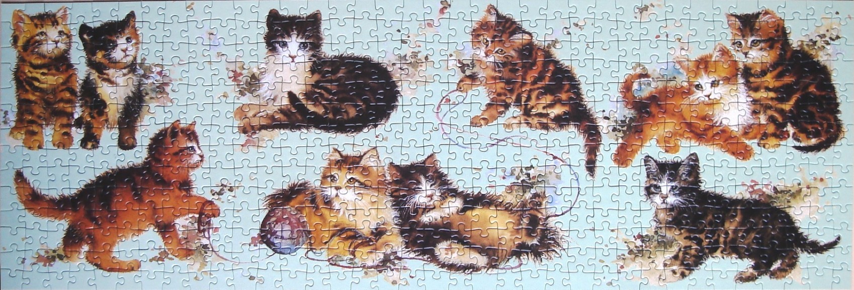 A panoramic illustration of eight kittens playing on a pale blue background.