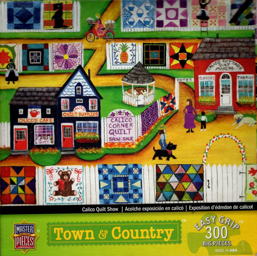 Folk art scene of a village street during a quilt show with colorful blankets hanging on white picket fences.