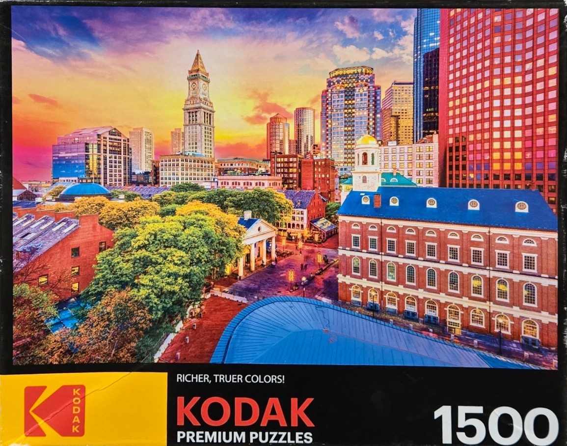Boston skyline at sunset featuring Faneuil Hall and the Custom House Tower