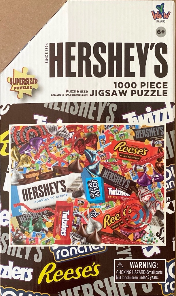 A colorful collage of popular American candy bars and treats scattered in a chaotic pile.