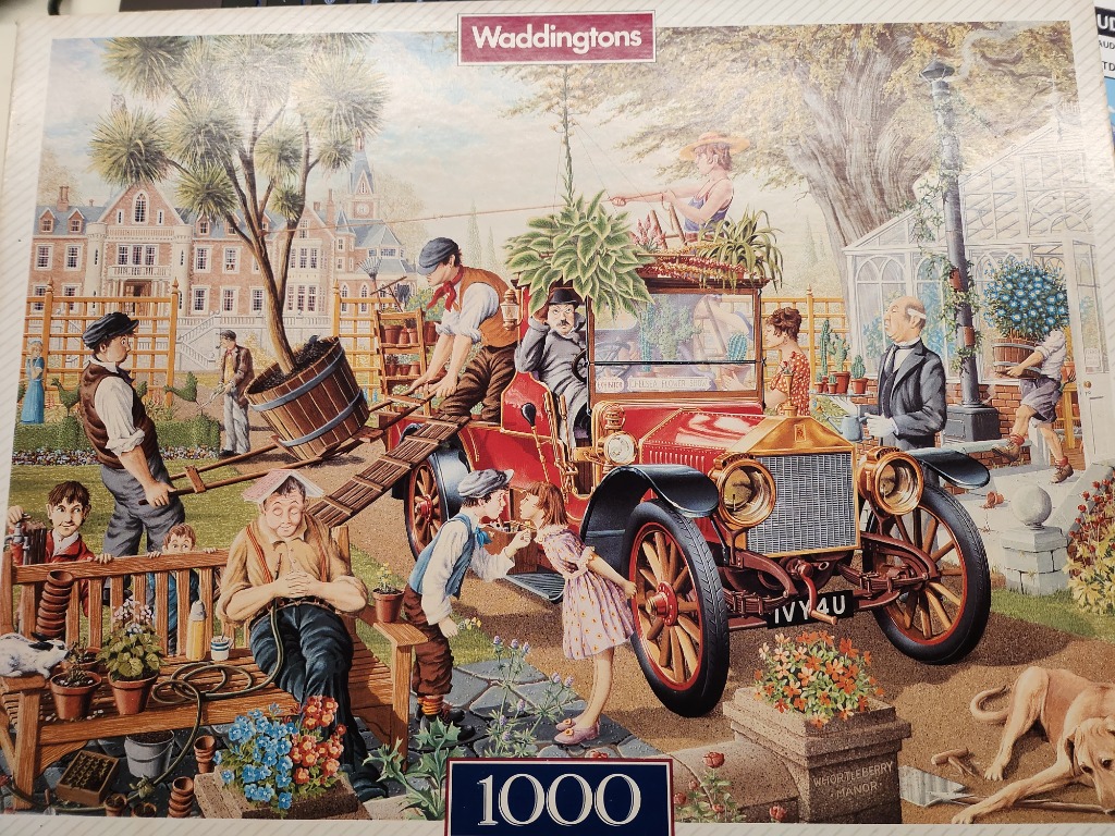 An illustration of people preparing a vintage red car for a flower show on the grounds of a large manor house.