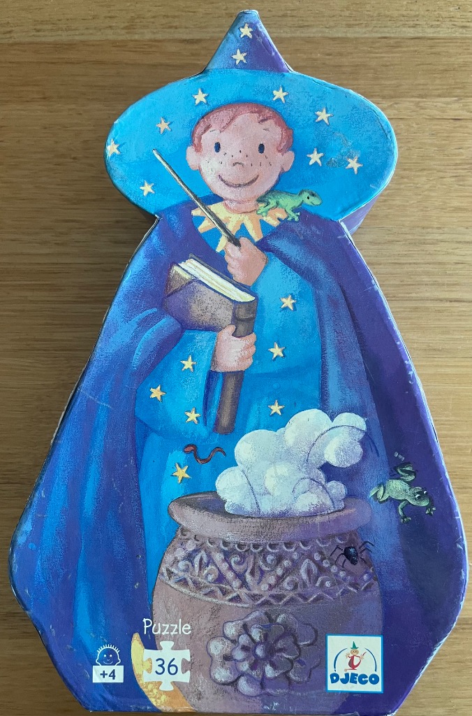 Illustration of a young wizard in a starry blue robe stirring a cauldron with a magic wand.
