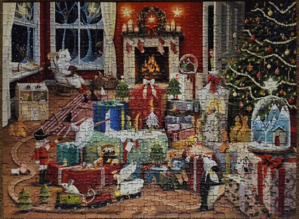 A cozy, illustrated Christmas scene featuring a polar bear reading in a chair by a fireplace and a decorated tree.