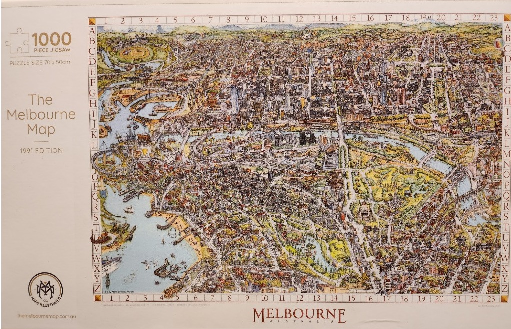 An aerial illustrated map of Melbourne, Australia, featuring a grid system around the border for coordinate tracking.