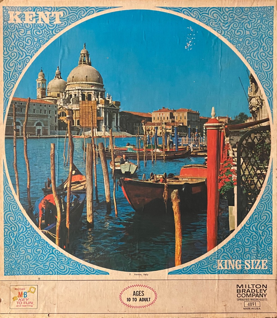 A view of the Basilica di Santa Maria della Salute in Venice, Italy, surrounded by canals and gondolas.