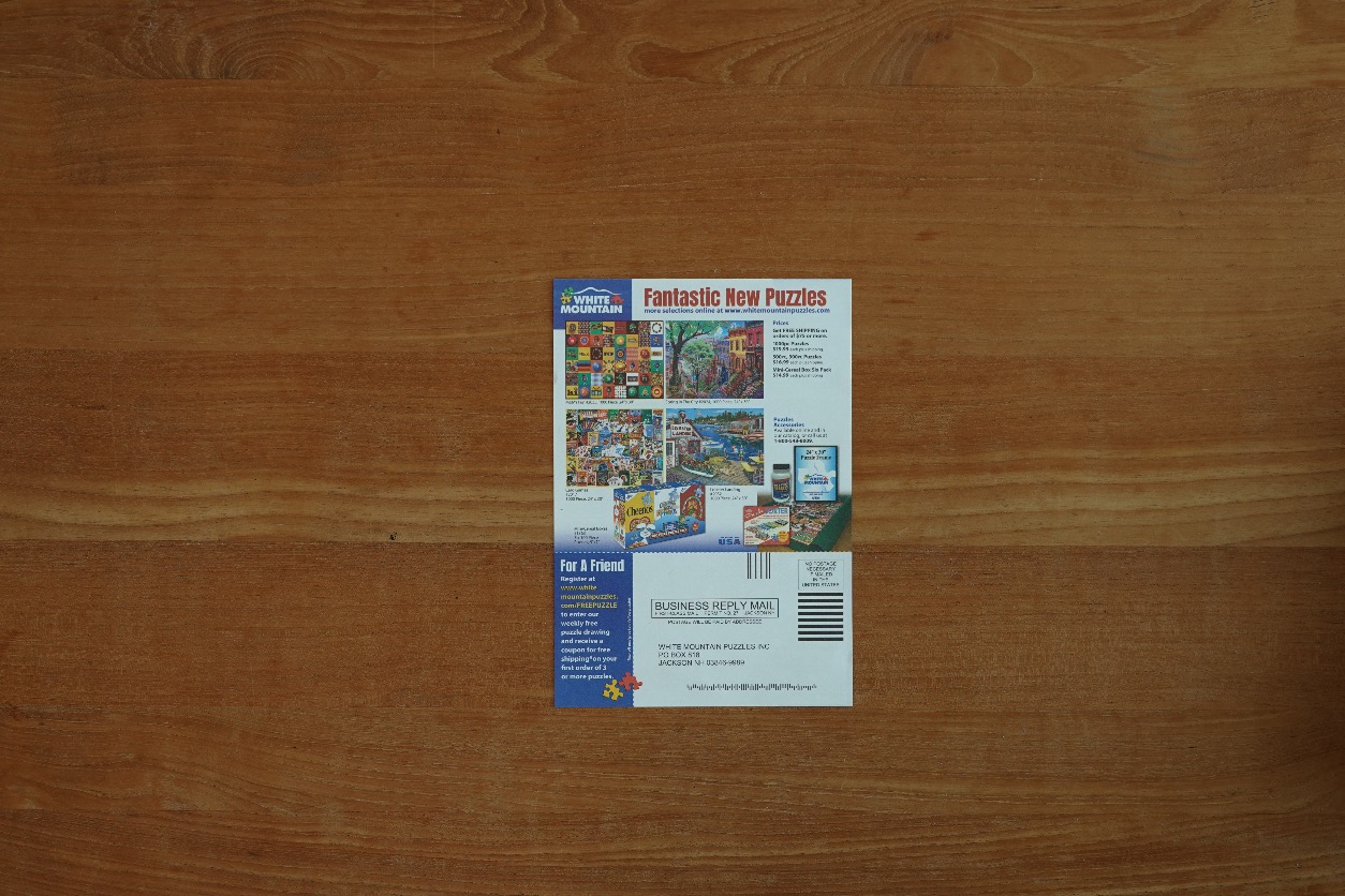 A rectangular promotional flyer for puzzles centered on a wood grain background.