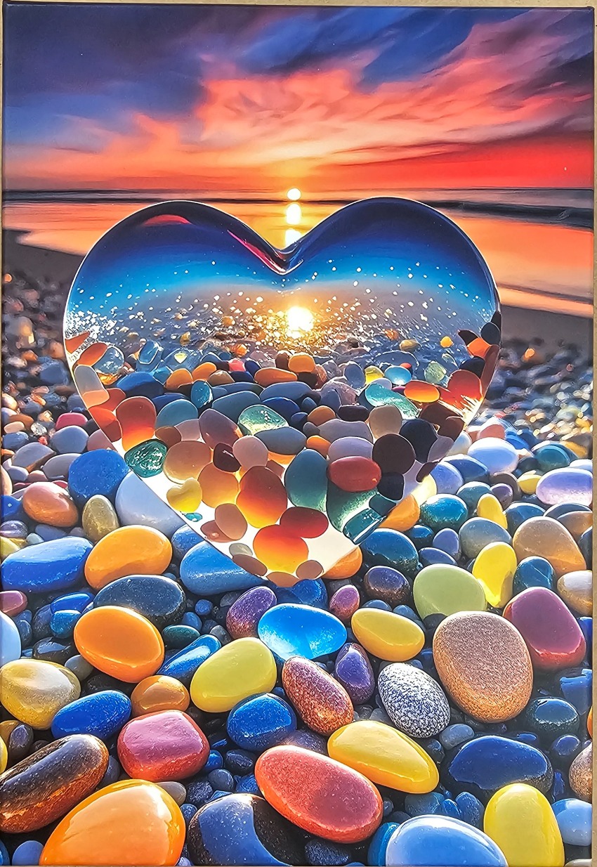 A heart-shaped glass sculpture filled with colorful polished stones set against a sunset beach background.
