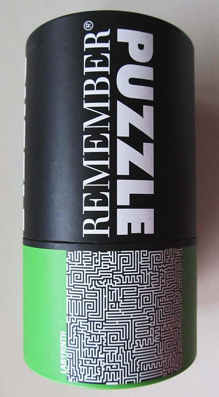 A cylindrical container featuring a high-contrast black-and-white maze pattern on a bright green background.