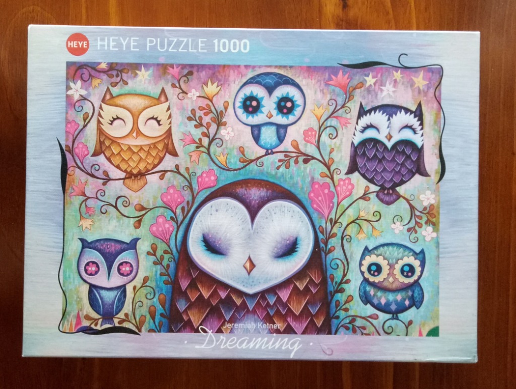 A whimsical illustration of five owls in various colors and sizes nestled among stylized, decorative floral vines.
