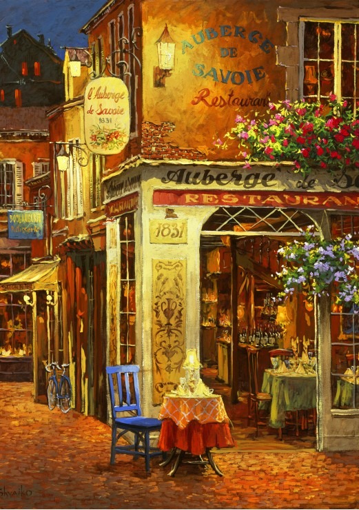 A cozy, lit-up corner restaurant in a European town at twilight, featuring a bistro table and chairs on a cobblestone street.