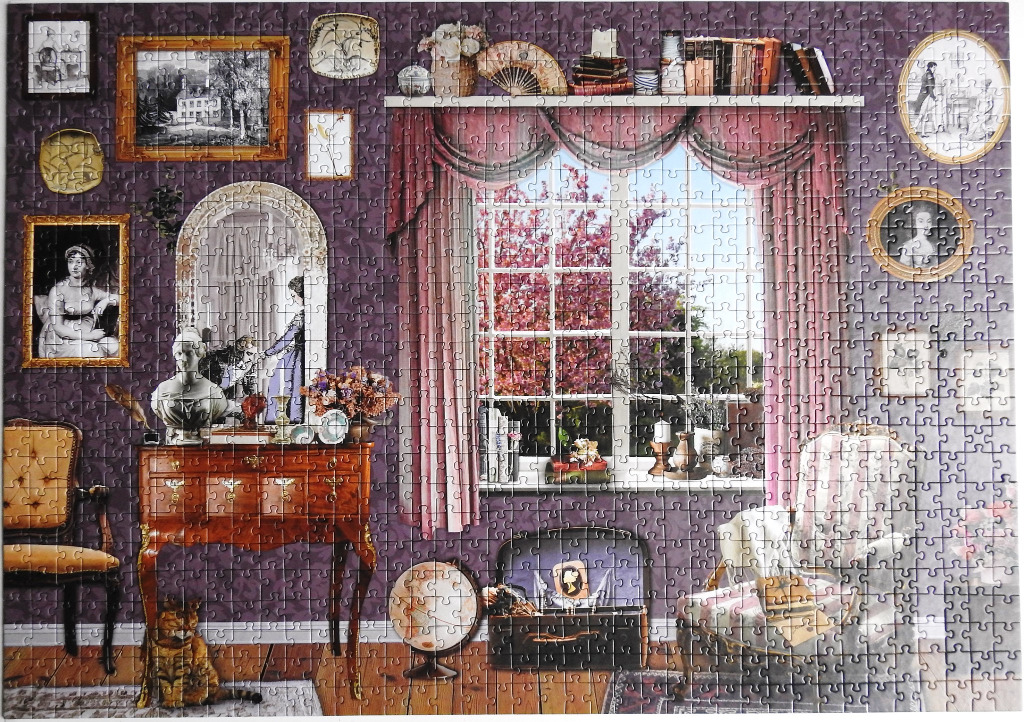A cozy, vintage-styled study or drawing room with a large window looking out onto blooming pink trees.