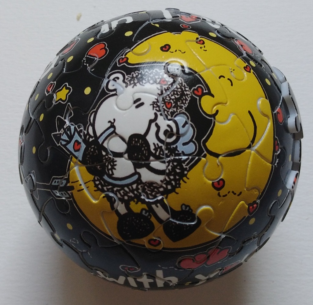 A spherical illustration of Snoopy hugging a large yellow moon against a black starry sky.